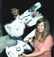 1990: White (front) with the model of the Freedom-class and a staffer holding that of the Niagara-class TNG: "The Best of Both Worlds, Part II"