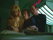 Kenneth and family around Belle's deathbed