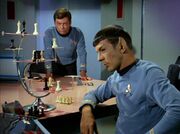 McCoy watches Spock play chess