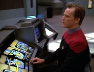 Tom Paris operates the helm console on the USS Voyager