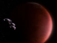 Ships of the Mars Defense Perimeter fly past Mars
