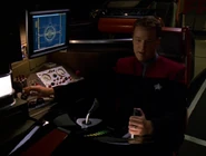 Tom Paris operates the helm's manual steering columns on the Delta Flyer