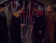 Bashir, O'Brien, Sisko, and Odo in front of Quark's