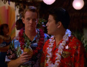 Kim and Paris wearing Hawaiian shirts and leis