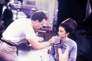 Doug Drexler adjusting the makeup on actress Juliana Donald