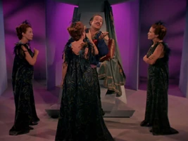 Three Stella androids scolding Harcourt Mudd