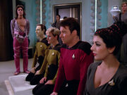 Enterprise-D away team kneels before Beata