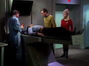 Leslie helping in sickbay