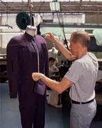 Ent Uniforms USA Weekend 3.jpg (13 KB) A costumer makes adjustments on a uniform.