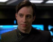 Lieutenant Ducane of the timeship USS Relativity in sciences grey, 29th century