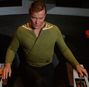 Kirk wearing green wraparound tunic, collar rank