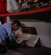 Spock opens engineering station's access panel