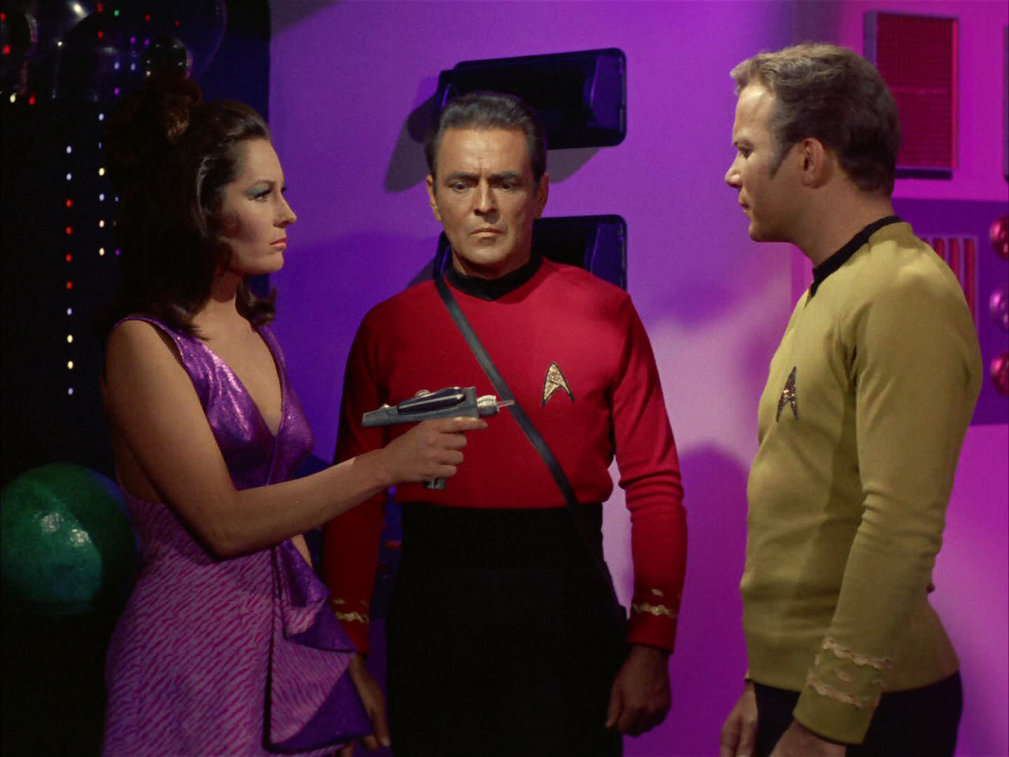 Kara aims phaser at James T. Kirk