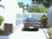 A car parked in a driveway at a house