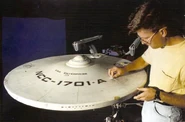 Bill George applying battle damage to USS Enterprise-A studio model.jpg (77 KB) 1991: Applying battle damage onto the refit Constitution II-class studio model Star Trek VI: The Undiscovered Country