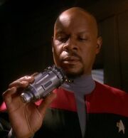 Sisko inspects a multidimensional transporter device