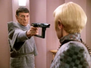 Spock aims disruptor rifle at Sela