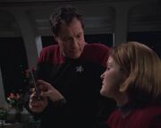 Q gives janeway a padd