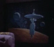 A starbase painting in Picard's quarters (TNG: "The Battle", "Angel One", "Pen Pals", "Allegiance", "Captain's Holiday", "Sarek", "Suddenly Human", "Legacy", "Qpid", "The Game", "I Borg", "Rascals", "A Fistful of Datas"; "Chain Of Command, Part I", "Lessons", "The Chase", "Suspicions", "Attached", "The Pegasus", "Journey's End", Star Trek Generations)