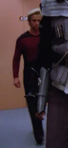 In a corridor Played by an unknown actor (TNG: "Heart of Glory")