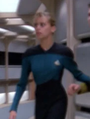 In a corridor Played by an unknown actress (TNG: "The Big Goodbye")