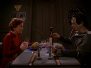 Table in center of room with entryway integrated into the wall