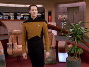 Spot sitting in captain's chair behind Data