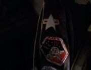 Starfleet combadge and Ares IV assignment patch