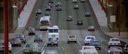 Automobiles driving down the Golden Gate Bridge in 1986