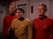 Chekov, Freeman and security guard arresting Kirk and Spock