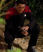 Chakotay holding shuttle debris