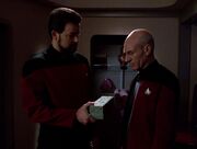 William T. Riker hands Jean-Luc Picard the Ressikan flute