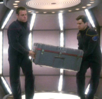 Tanner and crewman move cargo container