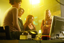 The Birds of Prey and Black Canary look at the computer at sunrise