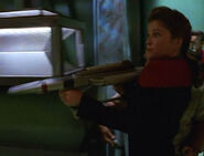 Kathryn Janeway holding a compression phaser rifle