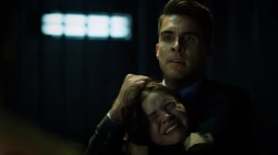 Adrian pretending to break Evelyn's neck