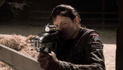 S Money aiming a particle rifle