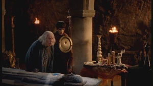 Merlin protects Gaius from a poisonous arrow.