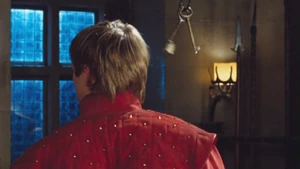 Merlin makes the keys fly behind Arthur's head.