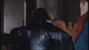 Merlin throws one of the Knights of Medhir into the wall.