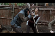 Gwen in combat, defends Hunith