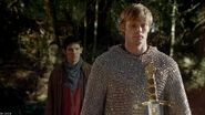 Merlin and Arthur with Excalibur before it is pulled from the stone.