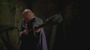 Alator attacks Morgana with his staff.