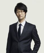 Kojima wearing a suit.