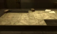 Maps, pointer, and blocks on a briefing table in the Bolshaya Past base.