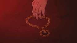 Ishnifus's medallion necklace is picked up by [who is presumably] Charles.