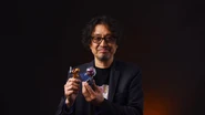 Sakamoto holding the two amiibo.