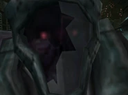 Close-up of the face. A pair of teeth can barely be made out, accompanying their frightening stare.