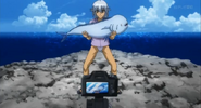 Tsubasa snaps a pic of his fish with his camera.