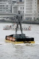 10-meter version of the statue, traveling through the River Thames